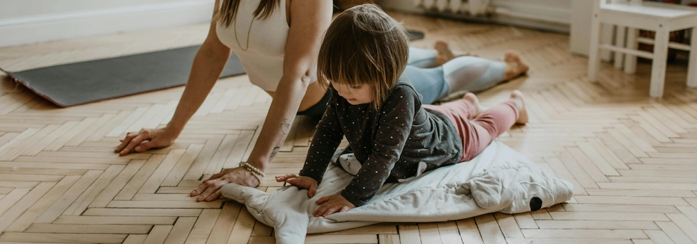 Toddler and mother practising kids yoga