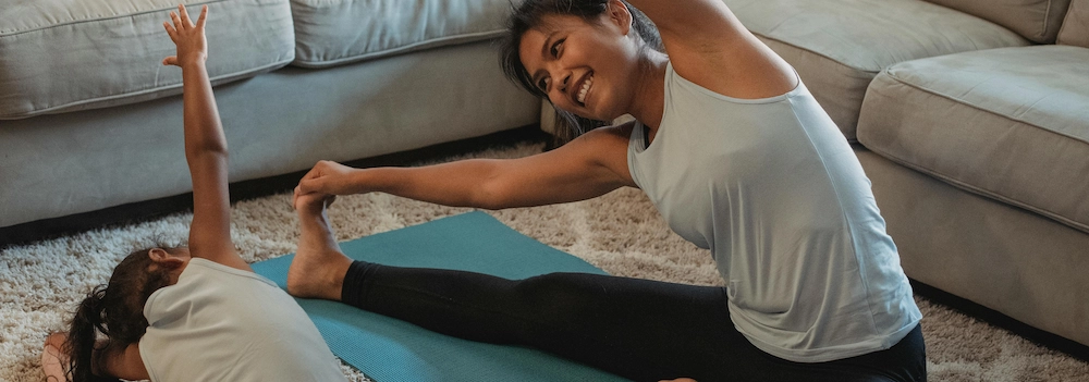 Mother and child practising yoga