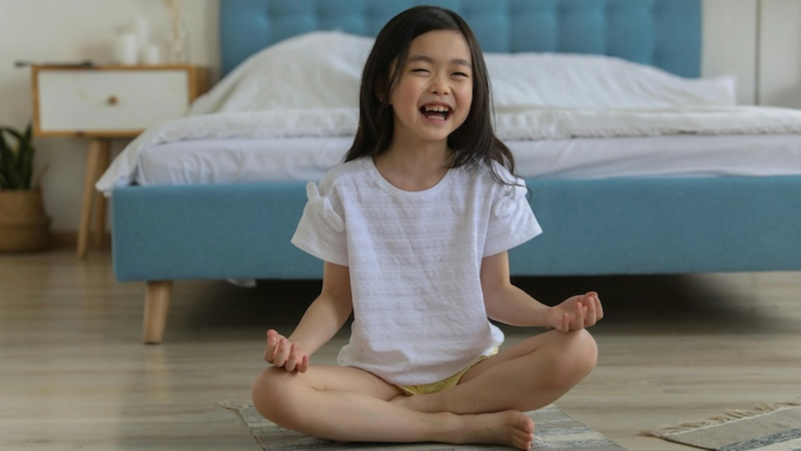 Little girl in lotus position (yoga)